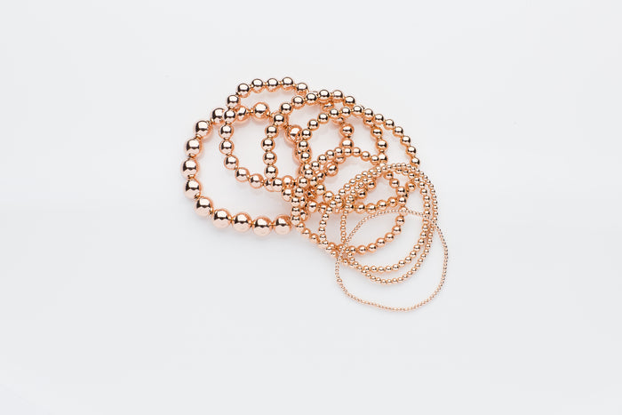 14k rose gold and 14k rose gold filled stretch bead bracelets, rings, necklaces and earrings